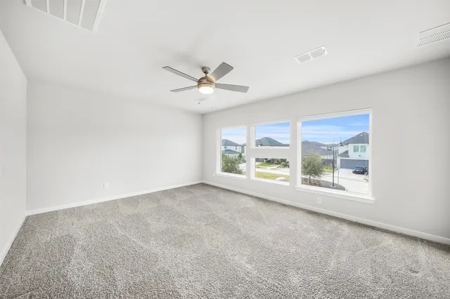 an empty room with closet and windows
