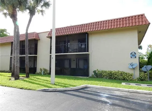 a view of a house with a garden and plants
