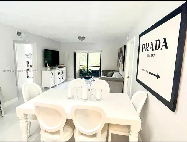 a living room with furniture and wall paintings