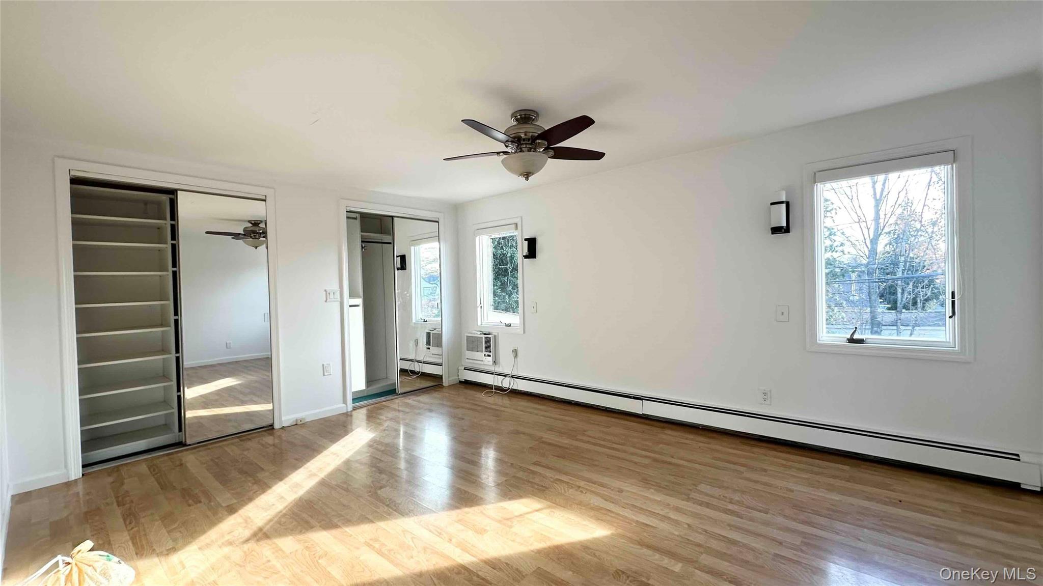 34 Marksman Lane Levittown, NY 11756 - Photo 12 of 15 wooden floor in an empty room with a window