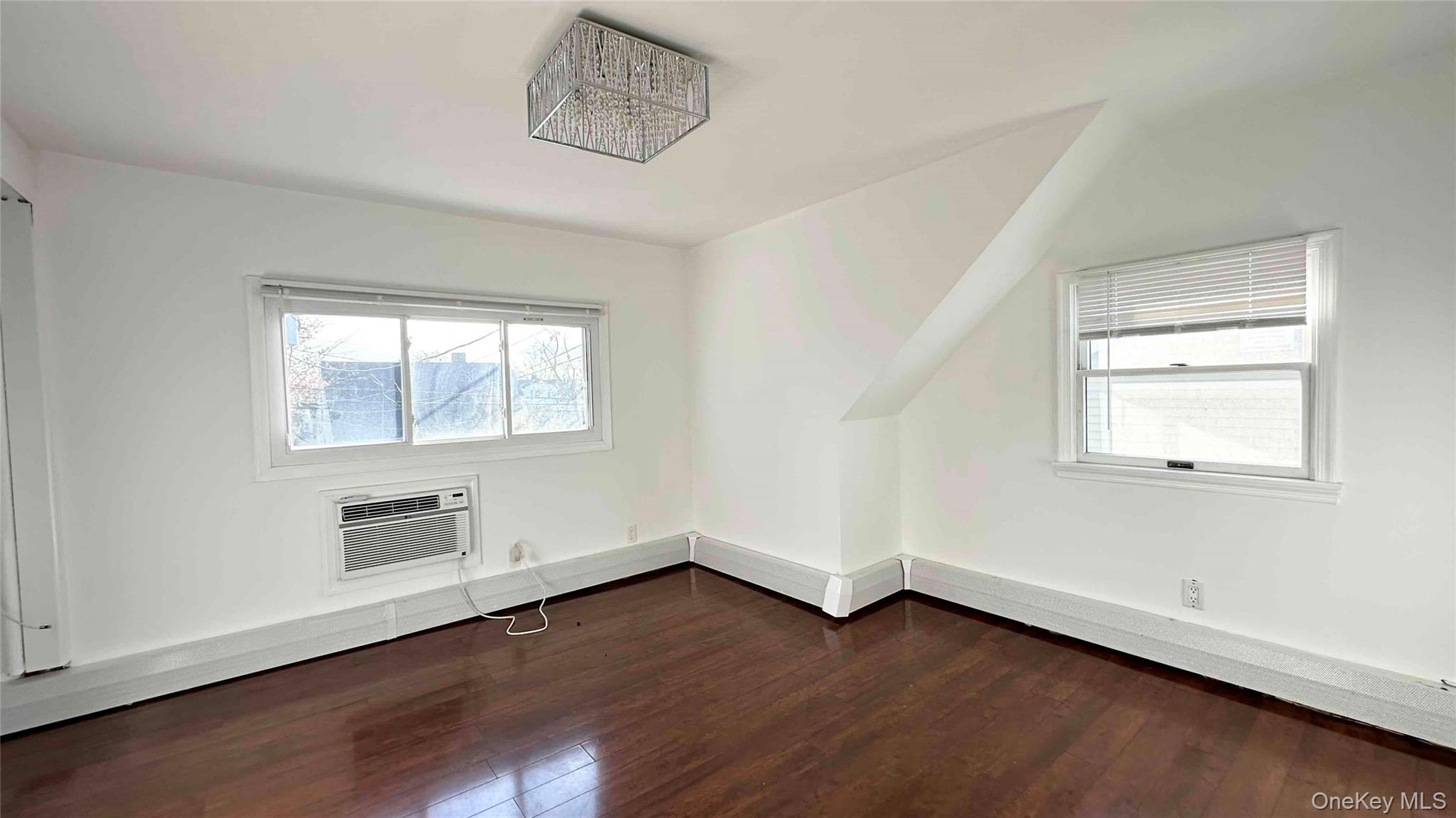 34 Marksman Lane Levittown, NY 11756 - Photo 13 of 15 an empty room with wooden floor and windows