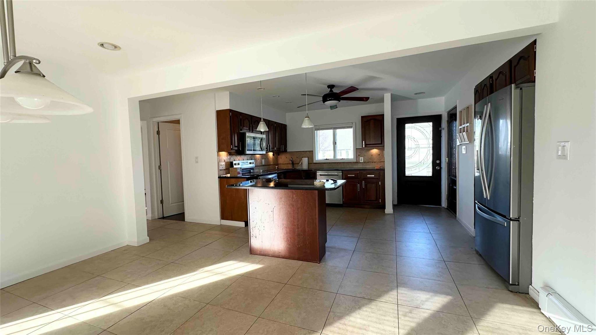 34 Marksman Lane Levittown, NY 11756 - Photo 2 of 15 a view of a kitchen and dining room with windows