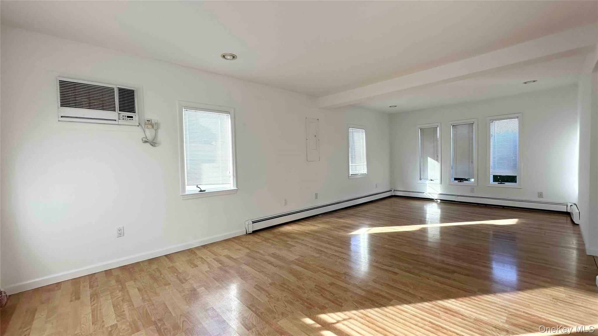 34 Marksman Lane Levittown, NY 11756 - Photo 4 of 15 a view of a livingroom with wooden floor and window