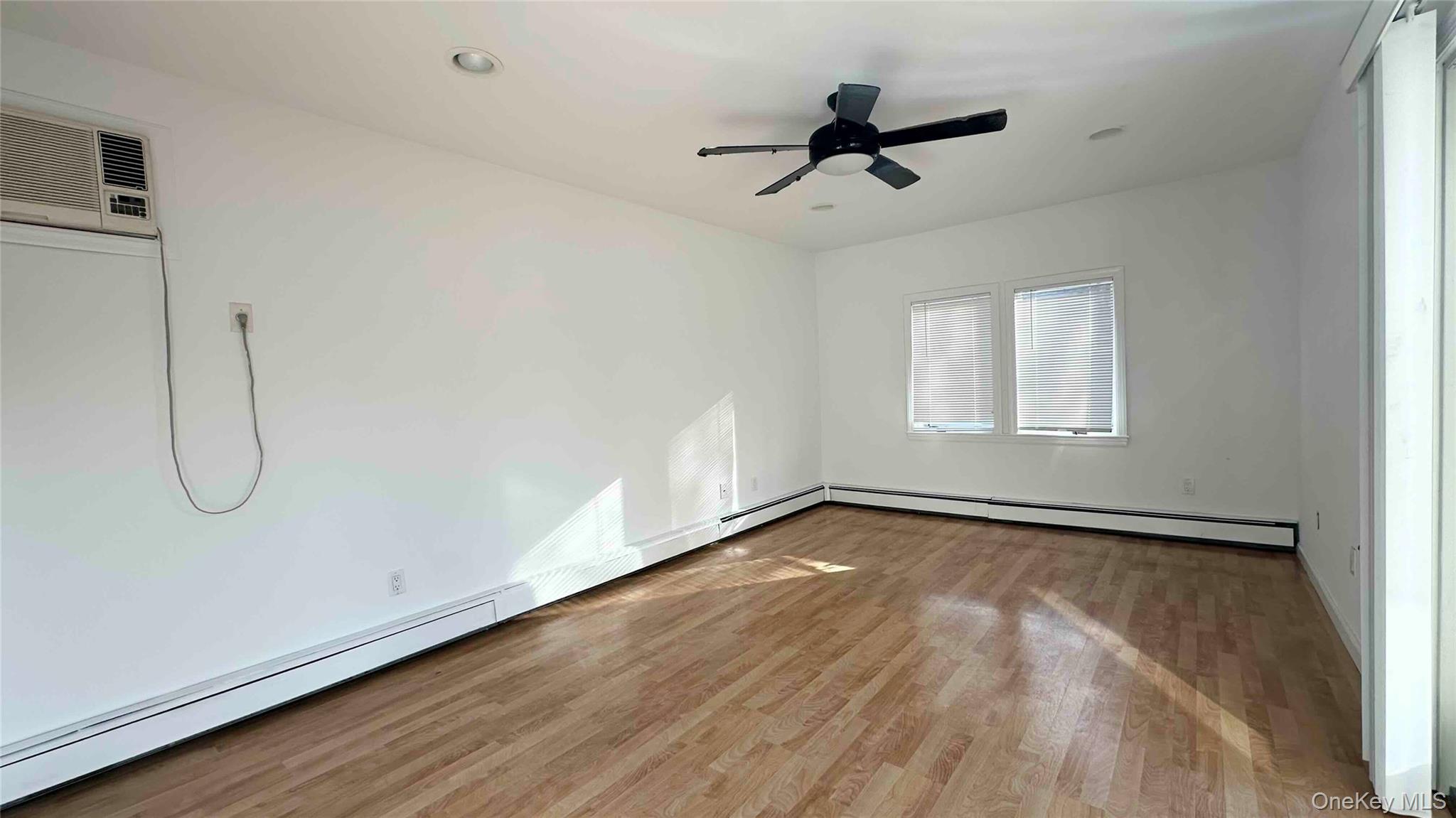 34 Marksman Lane Levittown, NY 11756 - Photo 6 of 15 a view of a room with wooden floor and windows