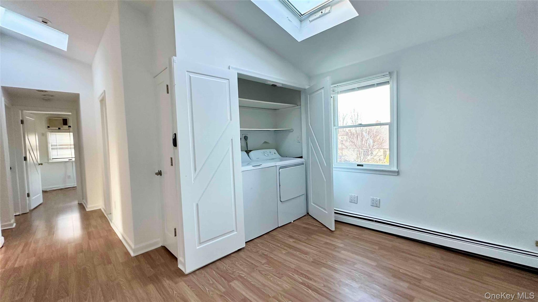 34 Marksman Lane Levittown, NY 11756 - Photo 8 of 15 an empty room with wooden floor and a window