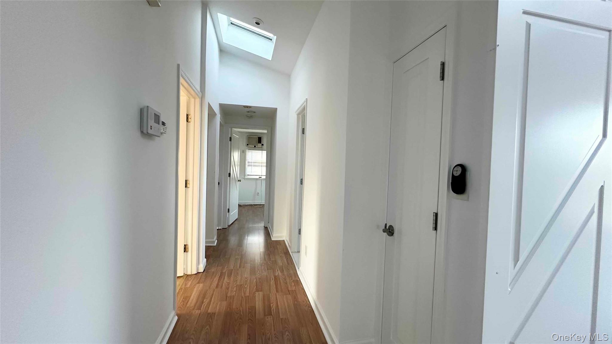 34 Marksman Lane Levittown, NY 11756 - Photo 9 of 15 a view of a hallway with wooden floor and a bathroom