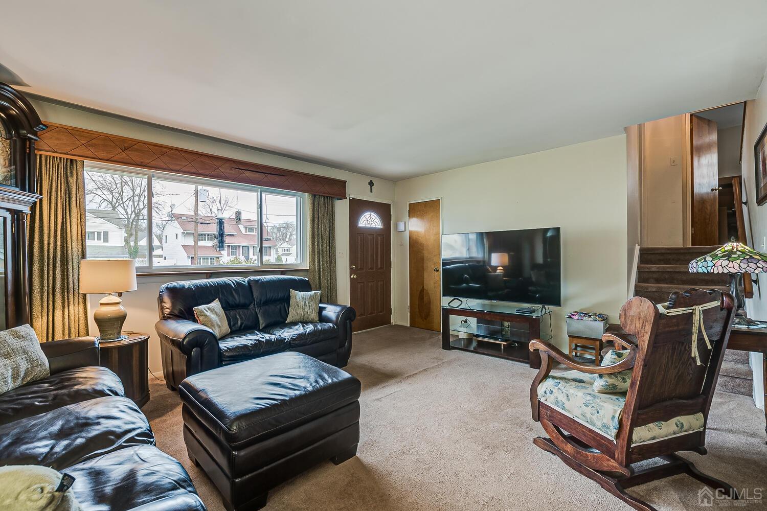 190 McFarlane Road Colonia, NJ 07067 - Photo 11 of 32 a living room with furniture and a flat screen tv