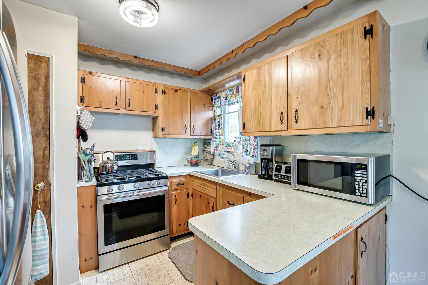 190 McFarlane Road Colonia, NJ 07067 - Photo 16 of 32 a kitchen with a stove a sink and a refrigerator
