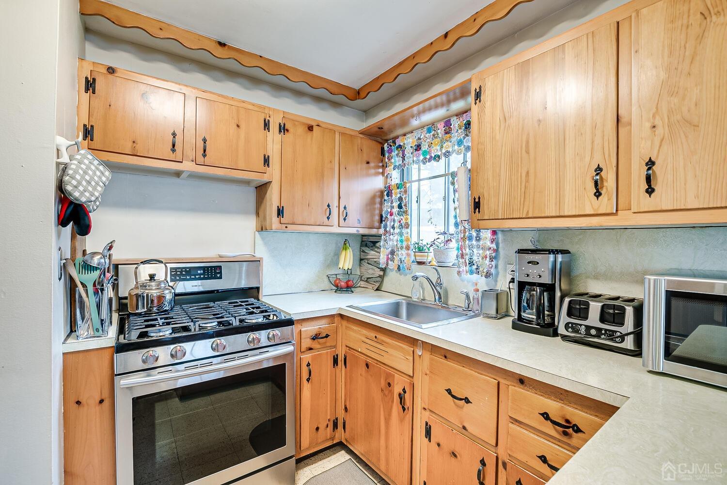 190 McFarlane Road Colonia, NJ 07067 - Photo 18 of 32 a kitchen with stainless steel appliances granite countertop a stove a sink and a refrigerator