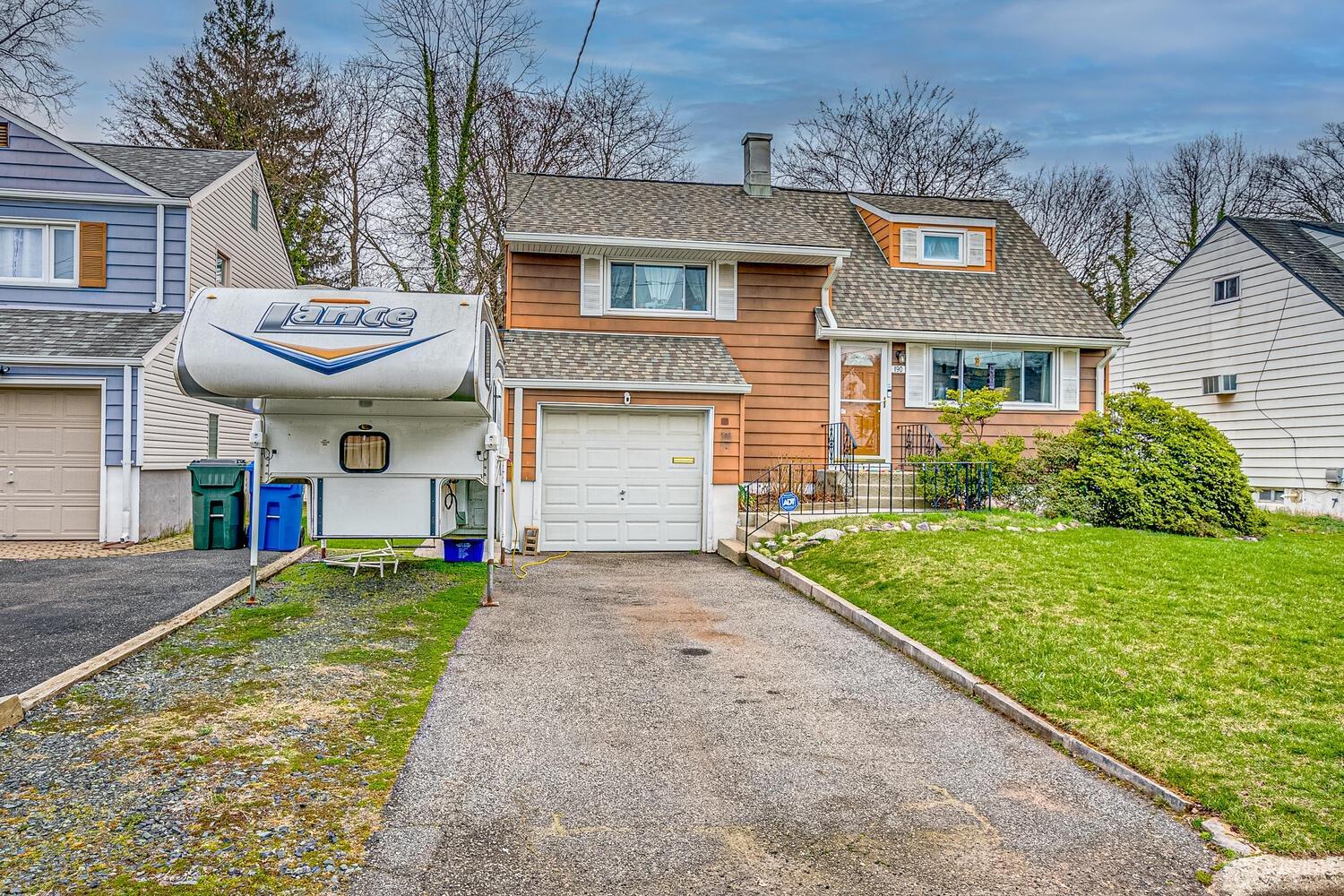 190 McFarlane Road Colonia, NJ 07067 - Photo 2 of 32 a front view of a house with a yard and garage