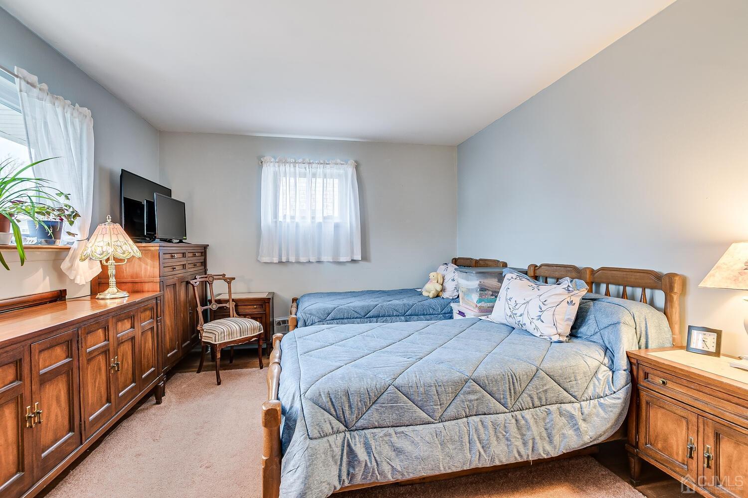 190 McFarlane Road Colonia, NJ 07067 - Photo 25 of 32 a bedroom with a bed and flat tv screen on the dresser