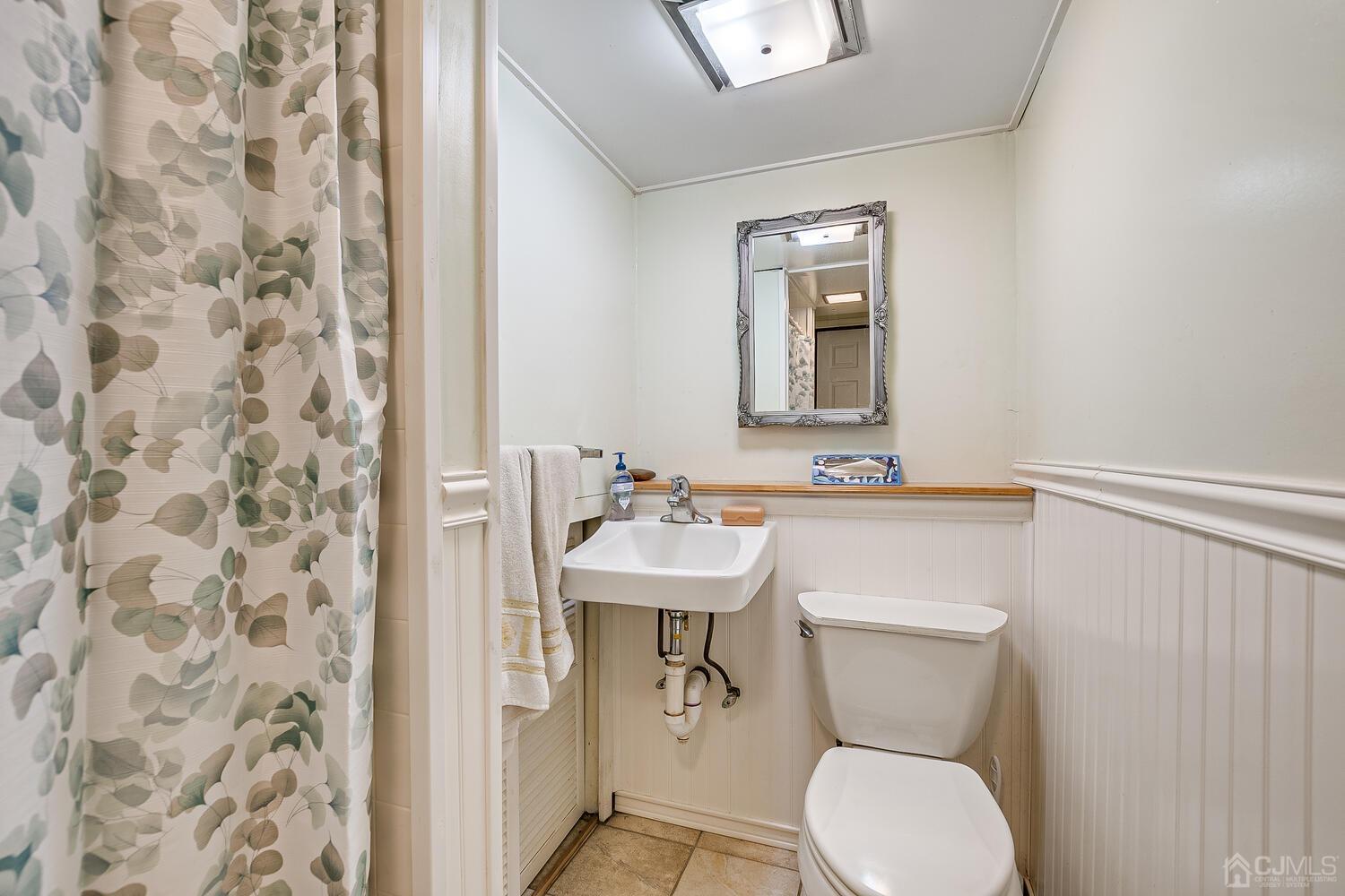 190 McFarlane Road Colonia, NJ 07067 - Photo 27 of 32 a bathroom with a toilet a sink and a mirror