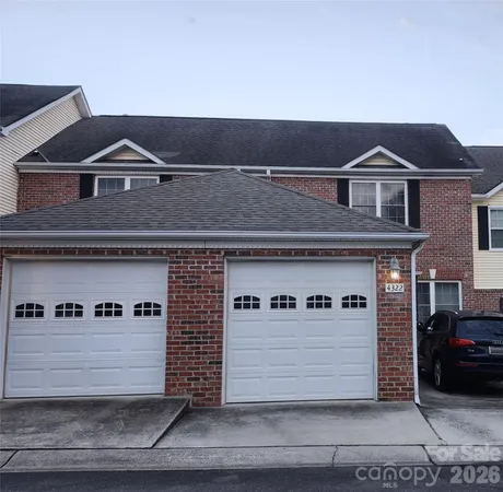 a front view of a house with parking area