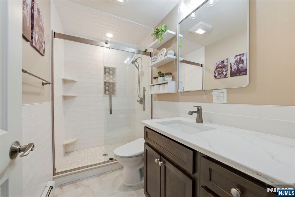 24 Maple Avenue Waldwick, NJ 07463 - Photo 15 of 45 a bathroom with a granite countertop sink mirror vanity and toilet