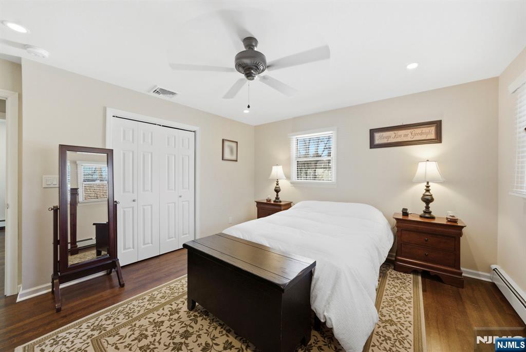 24 Maple Avenue Waldwick, NJ 07463 - Photo 17 of 45 a bedroom with a bed and a chandelier