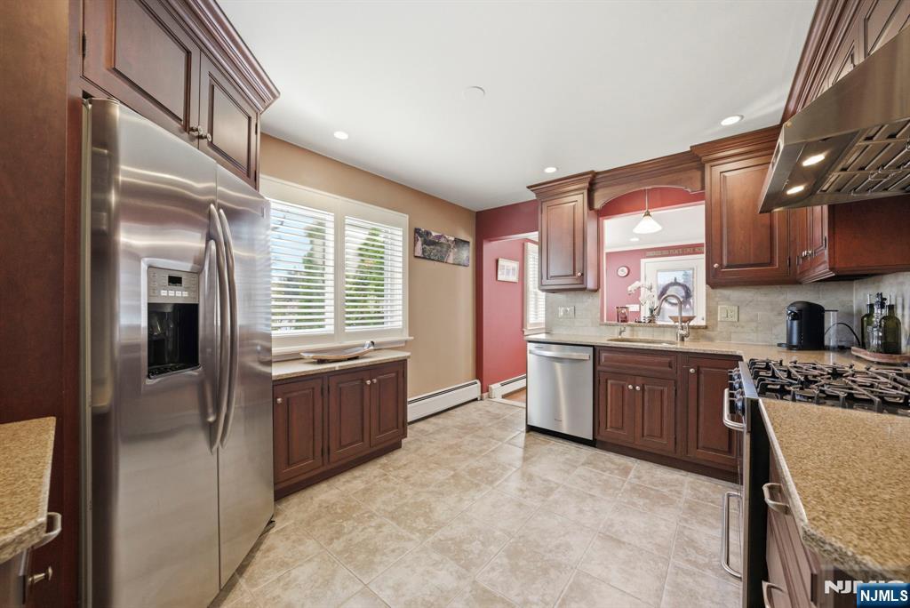 24 Maple Avenue Waldwick, NJ 07463 - Photo 23 of 45 a large kitchen with a stove a sink dishwasher and a refrigerator