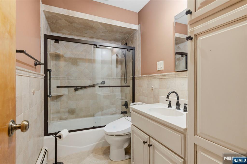 24 Maple Avenue Waldwick, NJ 07463 - Photo 30 of 45 a bathroom with a shower sink vanity mirror and toilet