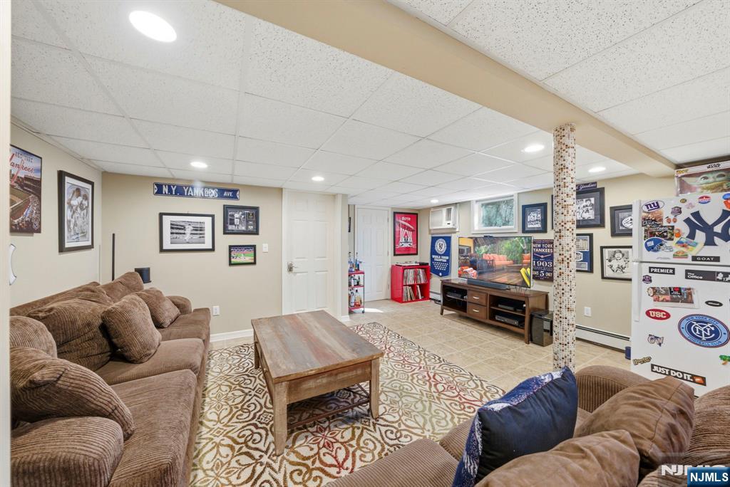 24 Maple Avenue Waldwick, NJ 07463 - Photo 33 of 45 a living room with furniture and a flat screen tv
