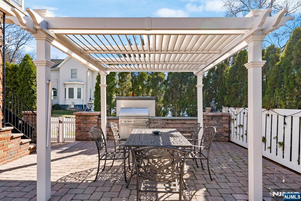 24 Maple Avenue Waldwick, NJ 07463 - Photo 38 of 45 a view of a patio with a table chairs and a backyard