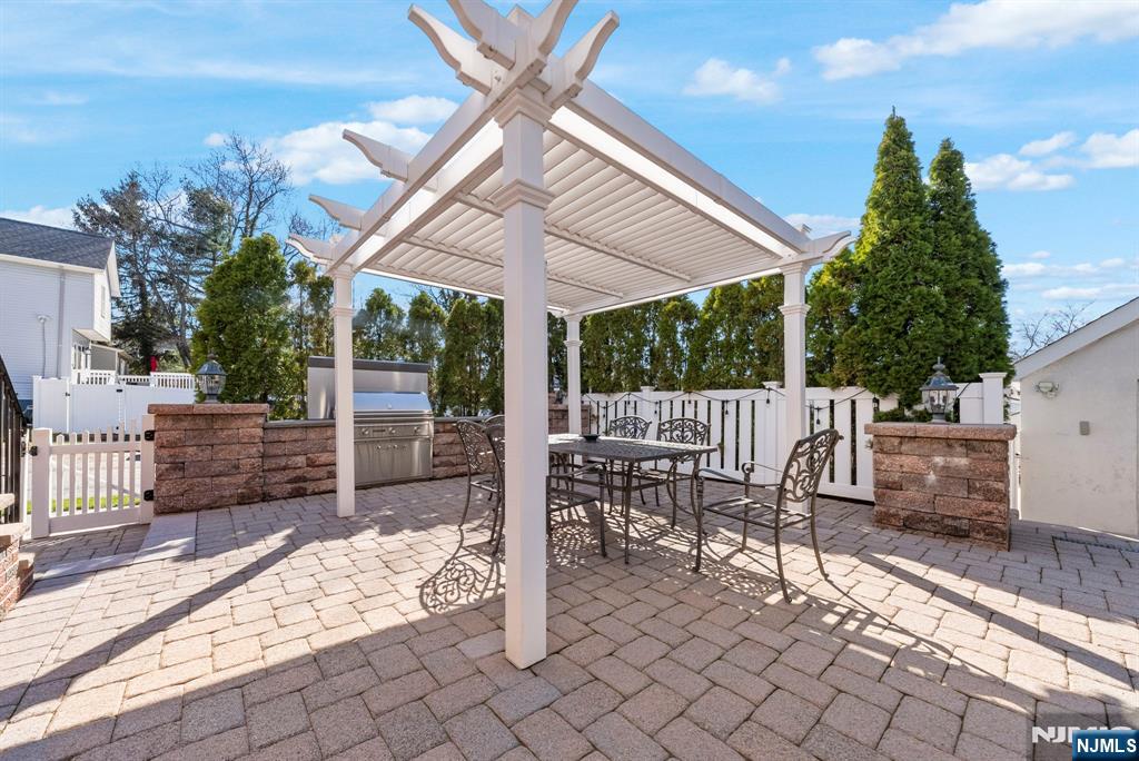 24 Maple Avenue Waldwick, NJ 07463 - Photo 40 of 45 a view of a patio with a table and chairs under an umbrella