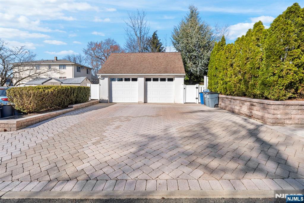 24 Maple Avenue Waldwick, NJ 07463 - Photo 42 of 45 a view of a house with a yard and potted plants