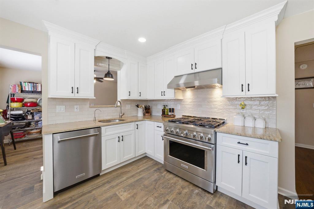 24 Maple Avenue Waldwick, NJ 07463 - Photo 6 of 45 a kitchen with stainless steel appliances granite countertop a stove and white cabinets