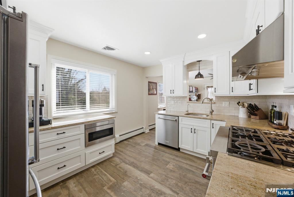24 Maple Avenue Waldwick, NJ 07463 - Photo 7 of 45 a kitchen with appliances a sink and cabinets