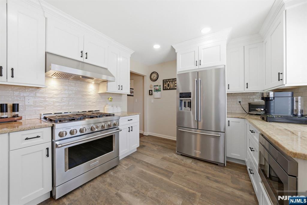 24 Maple Avenue Waldwick, NJ 07463 - Photo 8 of 45 a kitchen with stainless steel appliances a stove a refrigerator and a microwave