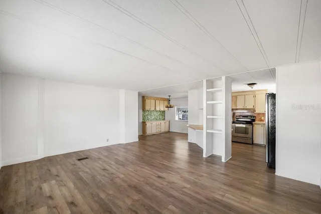 a view of a kitchen with a stove cabinets and wooden floor