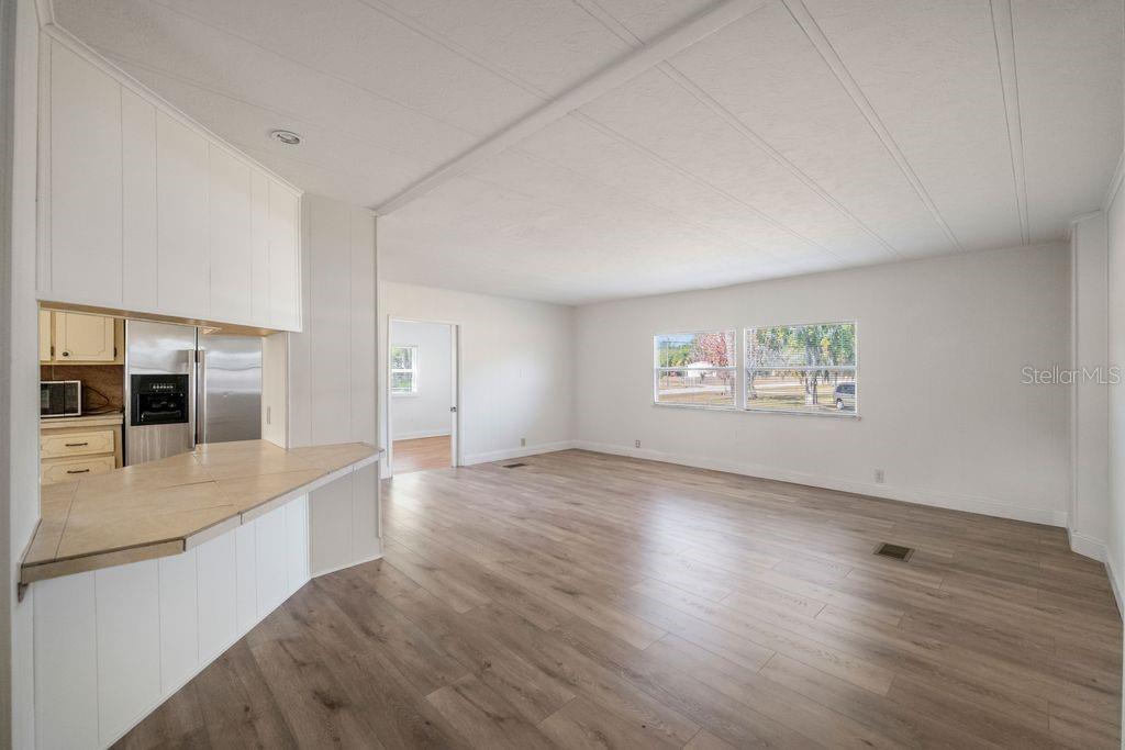 3648 Fox Ridge Boulevard Wesley Chapel, FL 33543 - Photo 13 of 30 an empty room with wooden floor and windows