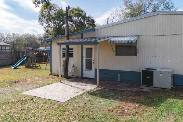 a view of a house with a backyard