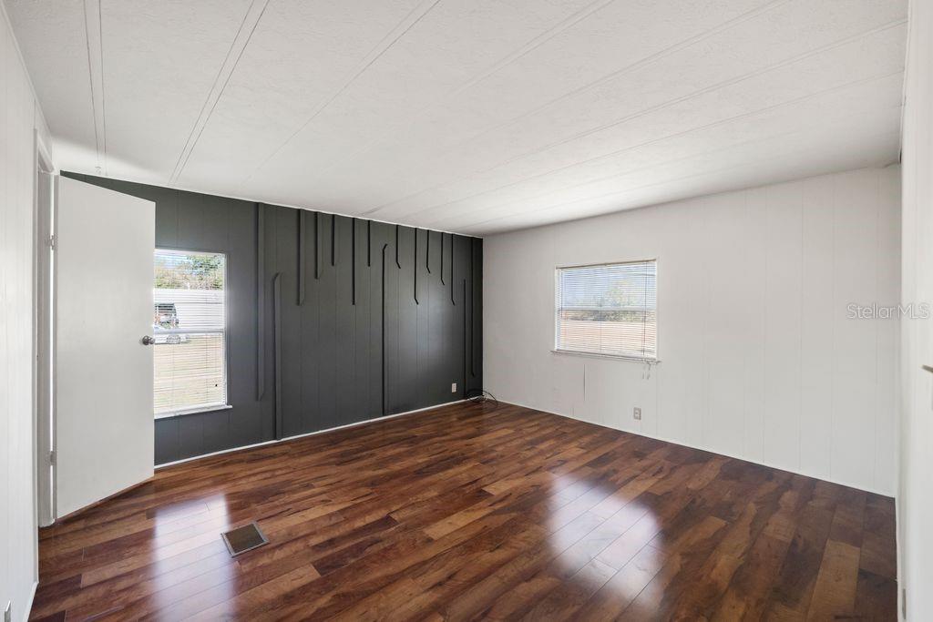 3648 Fox Ridge Boulevard Wesley Chapel, FL 33543 - Photo 18 of 30 a view of an empty room with wooden floor and a window