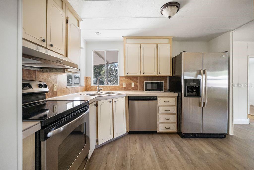 3648 Fox Ridge Boulevard Wesley Chapel, FL 33543 - Photo 22 of 30 a kitchen with a sink stainless steel appliances and cabinets