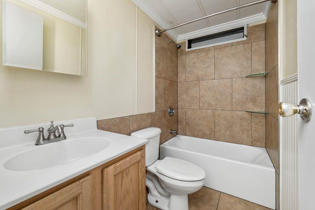 3648 Fox Ridge Boulevard Wesley Chapel, FL 33543 - Photo 26 of 30 a bathroom with a sink toilet and shower