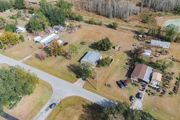 an aerial view of a house with a yard basket ball court and outdoor seating
