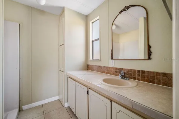 a bathroom with a sink a vanity and a mirror