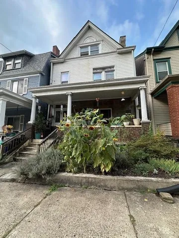 a front view of a house with garden
