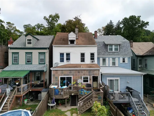 a picture of a living room with a table and a fireplace