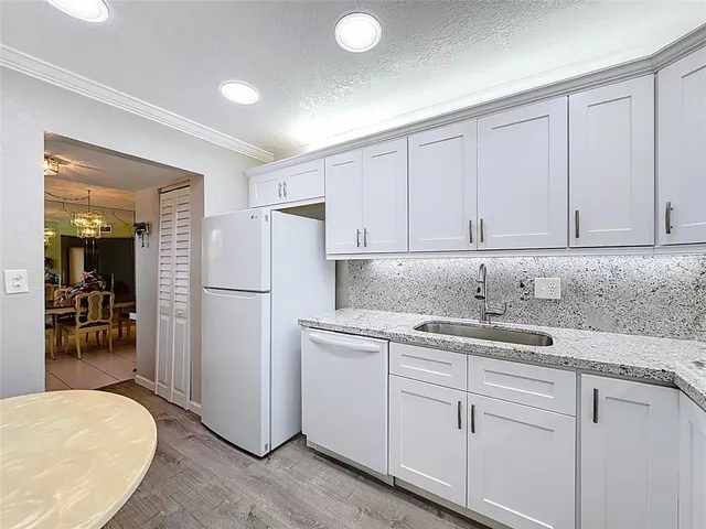 a kitchen with a sink and cabinets