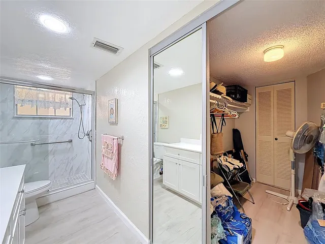 a bathroom with a double vanity sink toilet and mirror