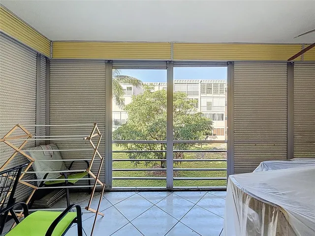 a living room with a bed and a large window
