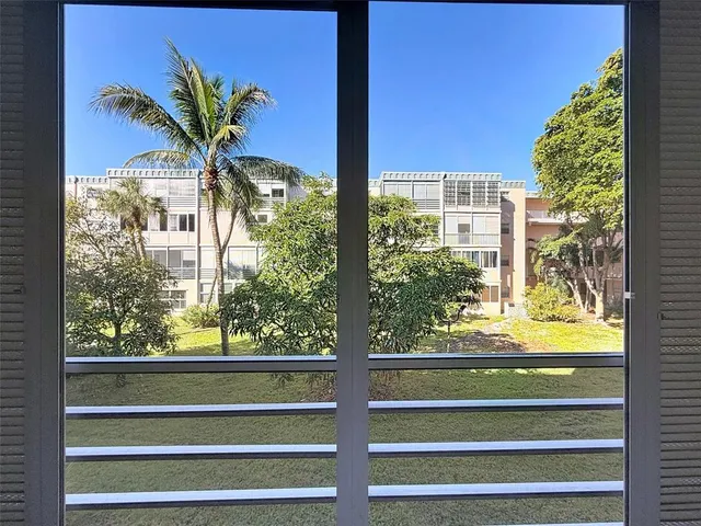 a front view of a building with a garden