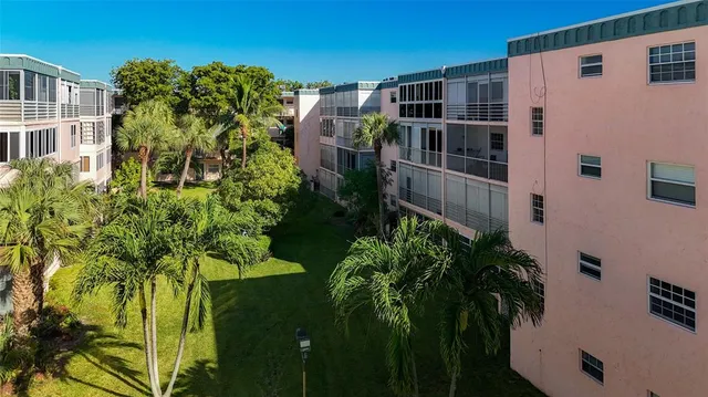 an aerial view of a city with lots of residential buildings and mountain view in back