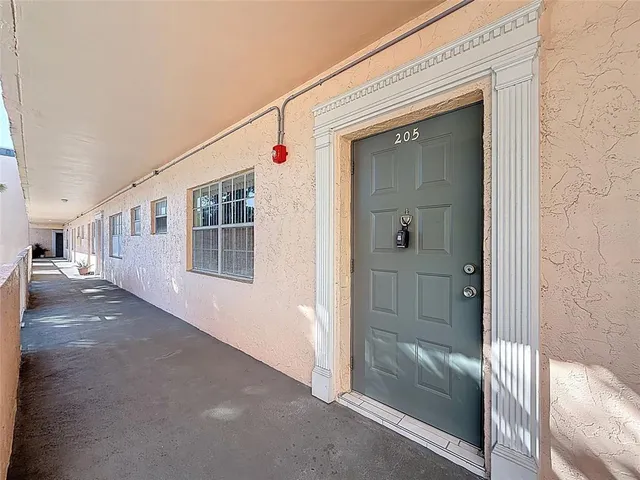 a view of a hallway with wooden floor and entryway