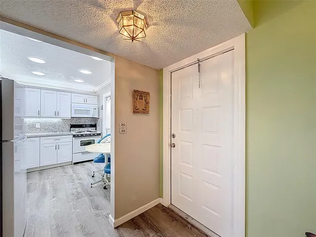 a kitchen with stainless steel appliances granite countertop a refrigerator and a stove top oven
