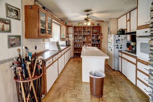 a kitchen with stainless steel appliances granite countertop a refrigerator and a stove