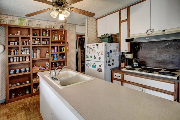 a kitchen with stainless steel appliances granite countertop a refrigerator and a stove top oven