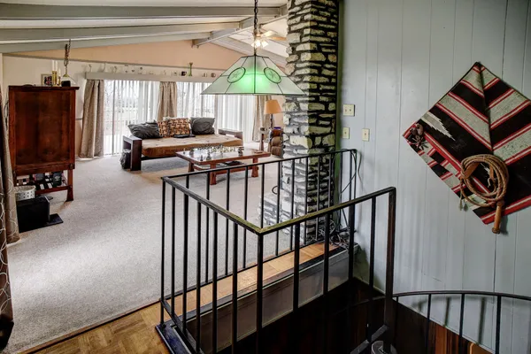 a view of staircase with furniture and a window