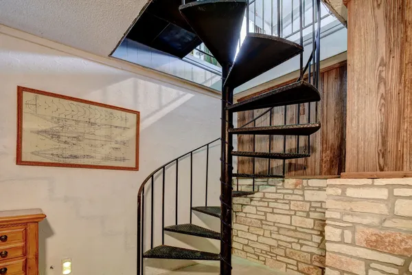 a view of staircase with white walls and a window