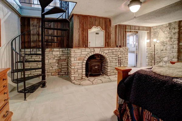 a bedroom with a bed and a fireplace